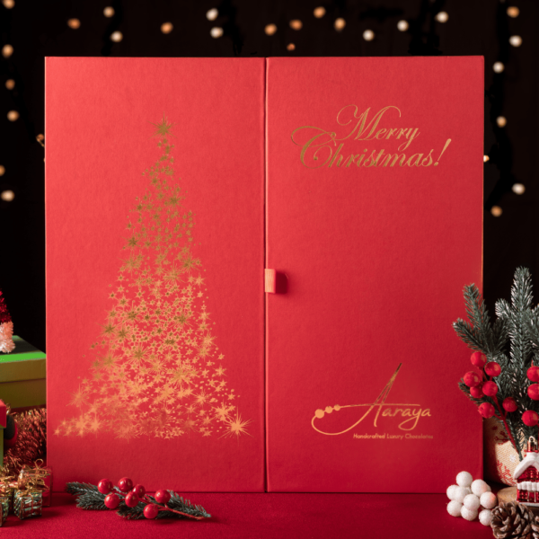 Decadent Santa and Christmas tree made from premium chocolate, adorned with festive chocolate balls – Aaraya Chocolatiers' luxurious Christmas hamper, a sensory delight for the holidays.