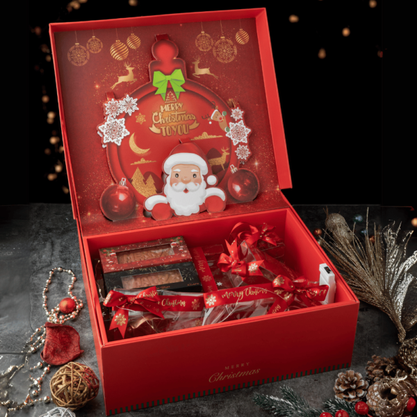 Indulge in Aaraya Chocolates' opulent Merry Christmas Hamper: a decadent blend of exquisite chocolates and festive figurines. Pure luxury in every bite and delightful detail.