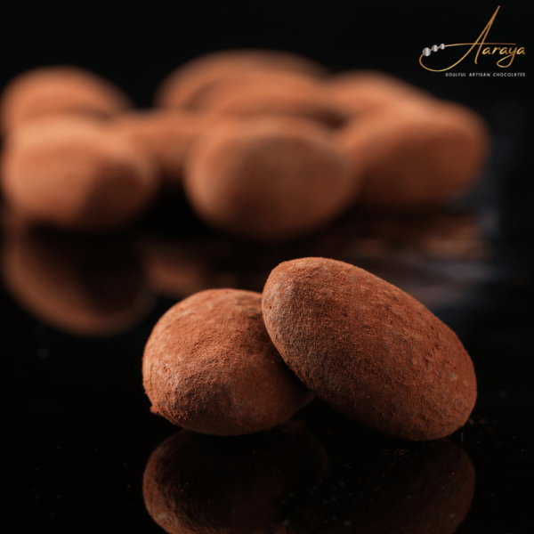 Close-up of Aaraya Chocolates' tempting Chocolate Coated Almonds, showcasing the perfect blend of premium nuts and luscious chocolate.