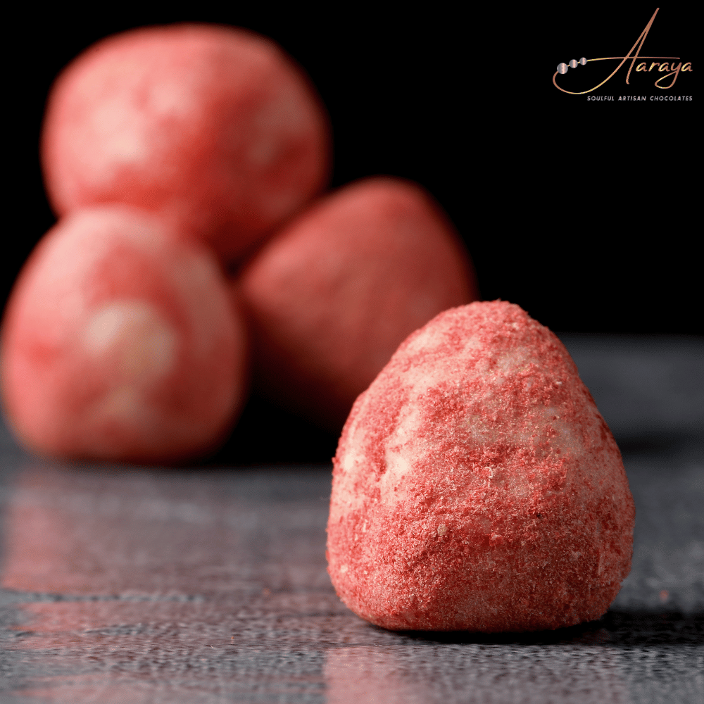 Strawberry Truffle by Aaraya Chocolates: A luxurious blend of real strawberries and velvety white chocolate, handcrafted for a unique sensory experience. Explore the best truffles in Dubai at Aaraya's boutique, a haven for chocolate enthusiasts.