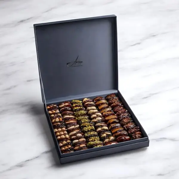 AARAYA® Silver Luxe Assorted Dates Gift Box showcasing an elegant silver box filled with premium gourmet dates and indulgent fillings like pistachio ganache, salted hazelnut, and orange peel.