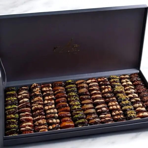 AARAYA® Silver Luxe Assorted Dates Gift Box - Large featuring a sleek silver box filled with 2.4 kg of premium gourmet dates and indulgent fillings such as pistachio ganache, salted hazelnut, and orange peel.