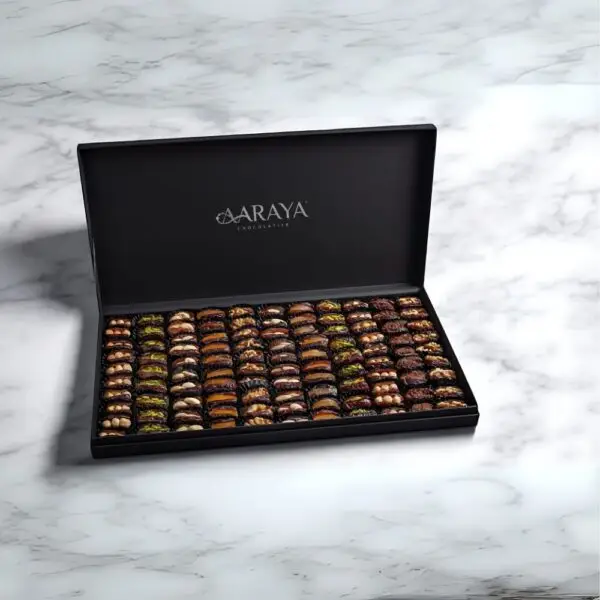 AARAYA® Noir Luxe Assorted Dates Gift Box - Large featuring an elegant black box filled with 2.4 kg of gourmet dates and indulgent fillings such as pistachio ganache, salted hazelnut, and orange peel.