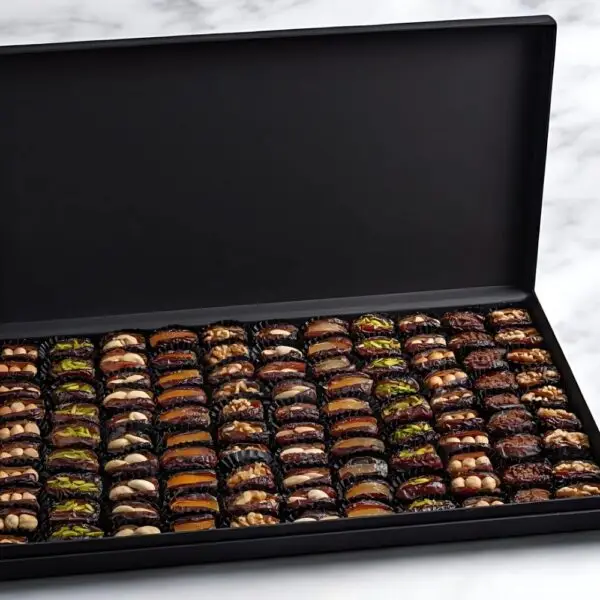 AARAYA® Noir Luxe Assorted Dates Gift Box - Large featuring an elegant black box filled with 2.4 kg of gourmet dates and indulgent fillings such as pistachio ganache, salted hazelnut, and orange peel.