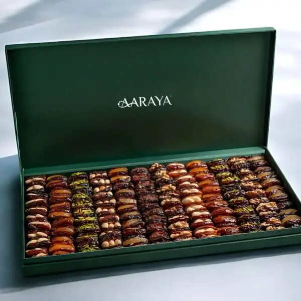 AARAYA® Emerald Luxe Assorted Dates Gift Box - Large featuring an elegant emerald-green box filled with 2.4 kg of gourmet dates with premium fillings such as pistachio ganache, salted hazelnut, and orange peel.