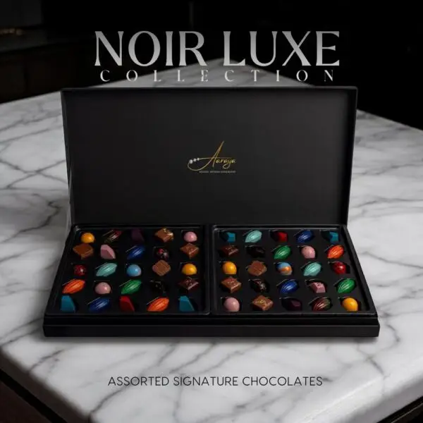 Discover the AARAYA® Assorted Chocolates Box - Noir Luxe Collection, a luxurious selection of handcrafted chocolates in an elegant black satin box. Perfect for gifting or indulging in premium chocolate bliss.