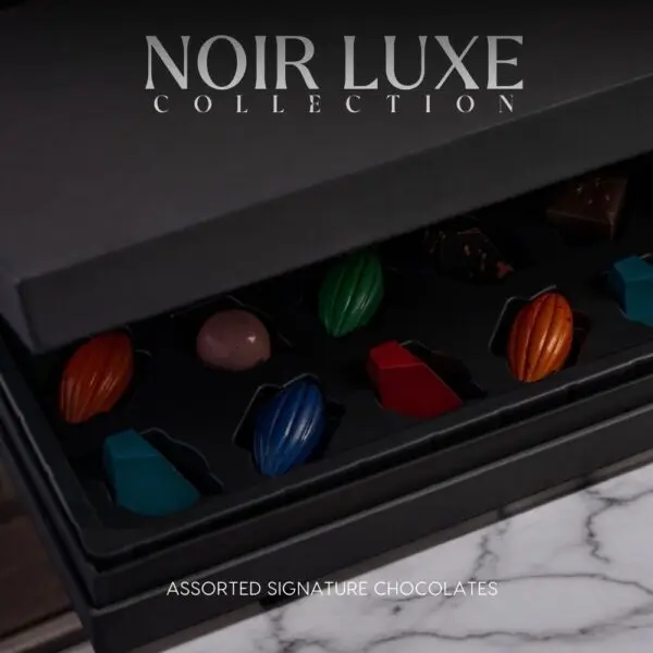 Discover the AARAYA® Assorted Chocolates Box - Noir Luxe Collection, a luxurious selection of handcrafted chocolates in an elegant black satin box. Perfect for gifting or indulging in premium chocolate bliss.