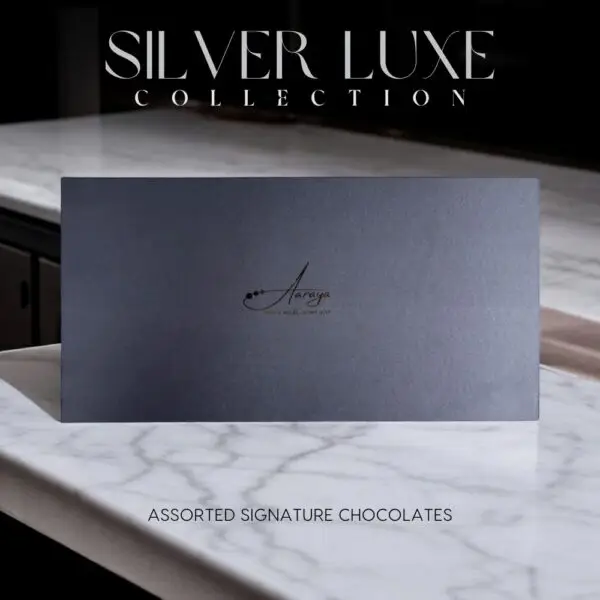 Discover the AARAYA® Assorted Chocolates Box - Silver Luxe Collection, a luxurious selection of handcrafted chocolates in an elegant silver satin box. Perfect for gifting or indulging in premium chocolate bliss.