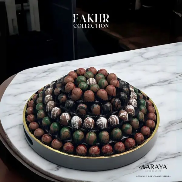 Elegant NATIONAL DAY FAKHR Collection by AARAYA® Chocolatier for UAE National Day, featuring 123 handcrafted premium chocolates in a 36 cm sophisticated display, celebrating the nation’s spirit of unity and heritage. Total weight of 2.9 kg, including 1.8 kg of artisanal chocolates. Available for AED 999