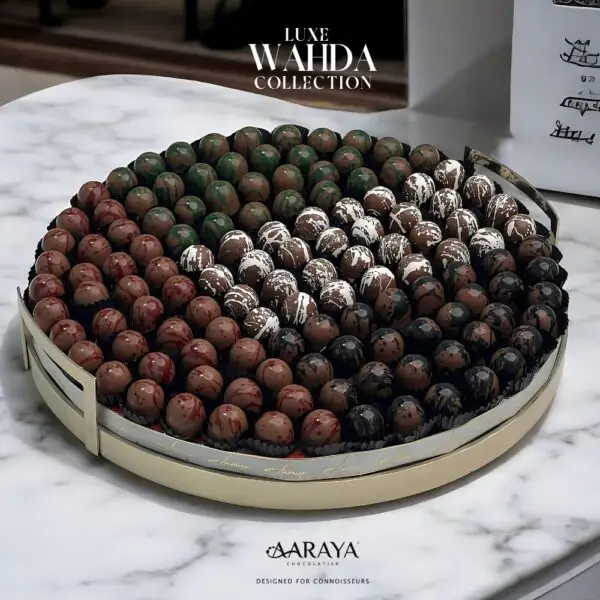 Elegant display of AARAYA® Chocolatier's LUXE WAHDA Collection for UAE National Day, featuring a luxurious arrangement of 129 handcrafted chocolates in a grand 40 cm display tray, showcasing premium flavors and exquisite designs, embodying unity and the spirit of the UAE. Available for purchase at AED 1,399