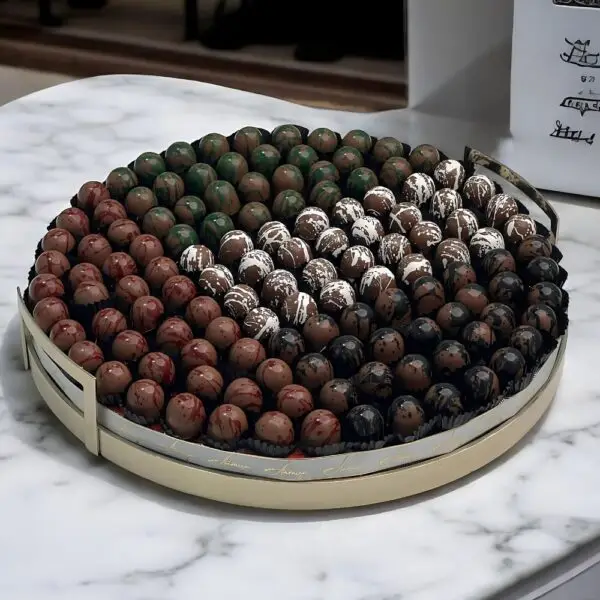 Elegant display of AARAYA® Chocolatier's LUXE WAHDA Collection for UAE National Day, featuring a luxurious arrangement of 129 handcrafted chocolates in a grand 40 cm display tray, showcasing premium flavors and exquisite designs, embodying unity and the spirit of the UAE. Available for purchase at AED 1,399