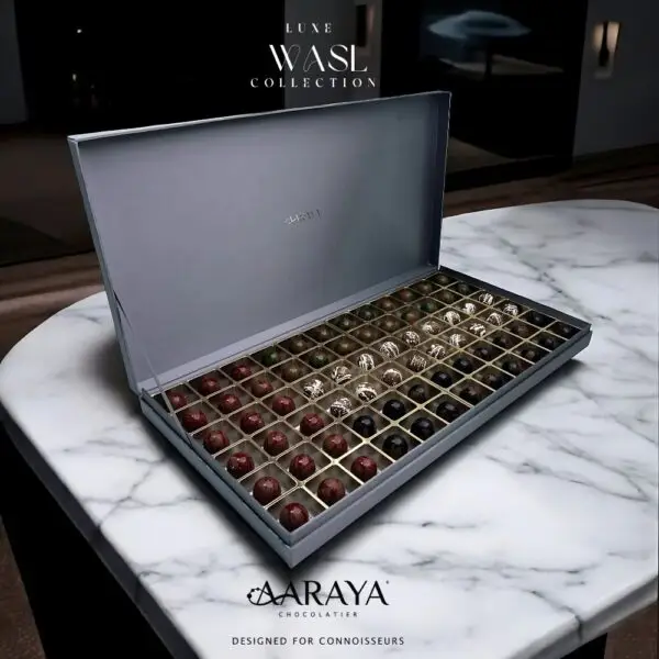 Luxurious WASL Collection by AARAYA® Chocolatier for UAE National Day, featuring an elegant assortment of handcrafted premium chocolates in various sizes and packaging. Celebrating unity, tradition, and pride with a range of boxes, including LUXE, NATIONAL, and PREMIUM editions, each box is crafted with the finest ingredients for a sophisticated chocolate experience