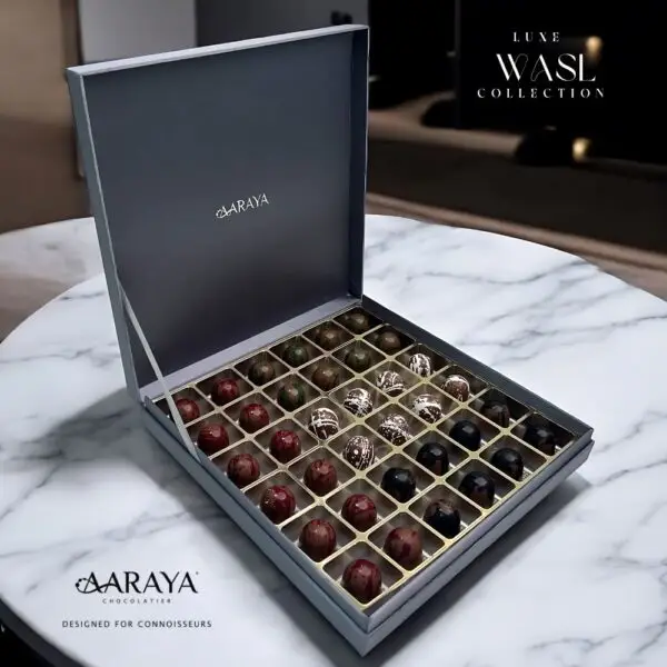 Luxurious WASL Collection by AARAYA® Chocolatier for UAE National Day, featuring an elegant assortment of handcrafted premium chocolates in various sizes and packaging. Celebrating unity, tradition, and pride with a range of boxes, including LUXE, NATIONAL, and PREMIUM editions, each box is crafted with the finest ingredients for a sophisticated chocolate experience