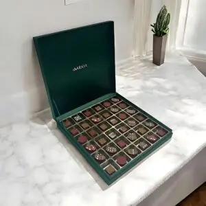 Emerald Luxe Festive Luxury Chocolates Box by AARAYA® featuring 36 handcrafted premium chocolates in an elegant emerald-inspired limited-edition packaging, perfect for Christmas gifting and celebrations.