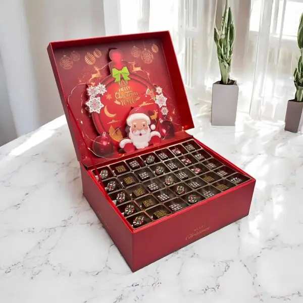 Golden Season Festive Chocolates Gift Box by AARAYA® featuring 105 handcrafted luxury chocolates in Santa Claus-inspired packaging, perfect for Christmas gifting.