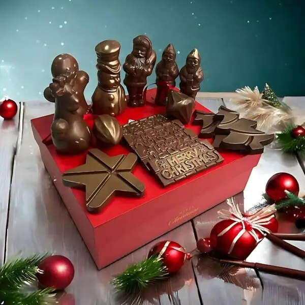 Merry Christmas Festive Chocolate Hamper by AARAYA® featuring handcrafted luxury chocolate figurines and bars, elegantly packaged in a premium hamper box. Perfect for gifting and holiday celebrations.