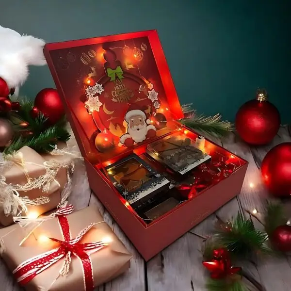 Merry Christmas Festive Chocolate Hamper by AARAYA® featuring handcrafted luxury chocolate figurines and bars, elegantly packaged in a premium hamper box. Perfect for gifting and holiday celebrations.