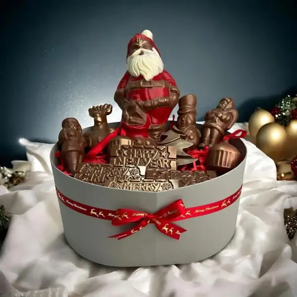 Luxury Christmas chocolate hamper by AARAYA®, featuring handcrafted premium chocolate figurines like Santa Claus, reindeer, snowman, and Christmas tree bars, elegantly packaged in a festive luxury box. Perfect for gifting and holiday celebrations.