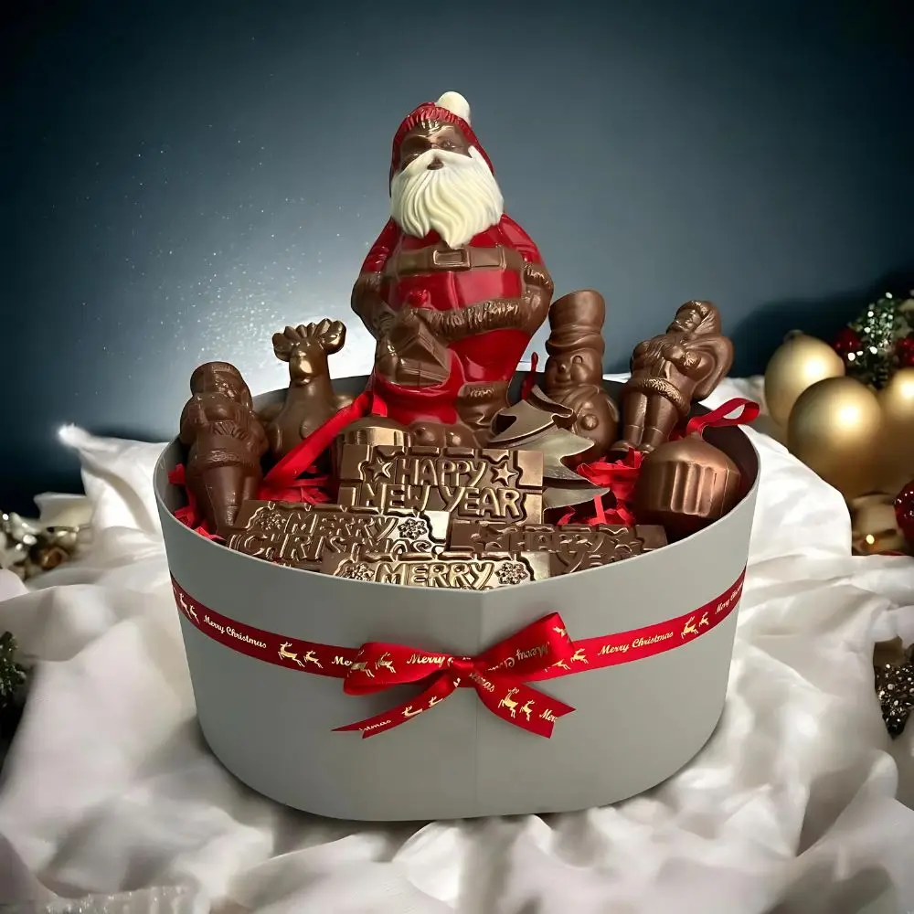 Luxury Christmas chocolate hamper by AARAYA®, featuring handcrafted premium chocolate figurines like Santa Claus, reindeer, snowman, and Christmas tree bars, elegantly packaged in a festive luxury box. Perfect for gifting and holiday celebrations.