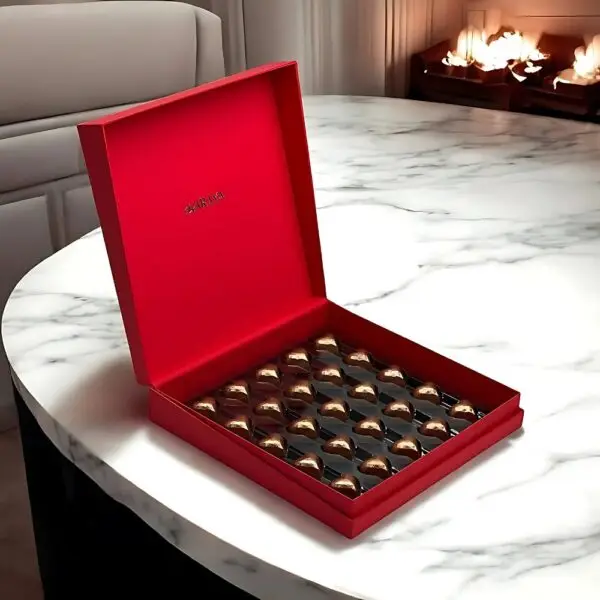 Valentine’s Day Signature Chocolate Love Box by AARAYA® featuring 40 golden heart-shaped chocolates in a luxurious black and red patterned design.