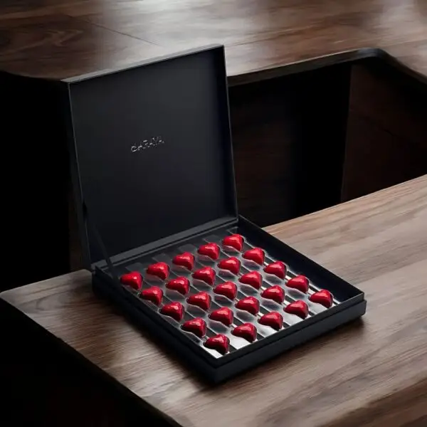 Opulence Valentine’s Collection: Premium Love Box by AARAYA®, featuring 25 red heart-shaped premium chocolates in a sleek black box