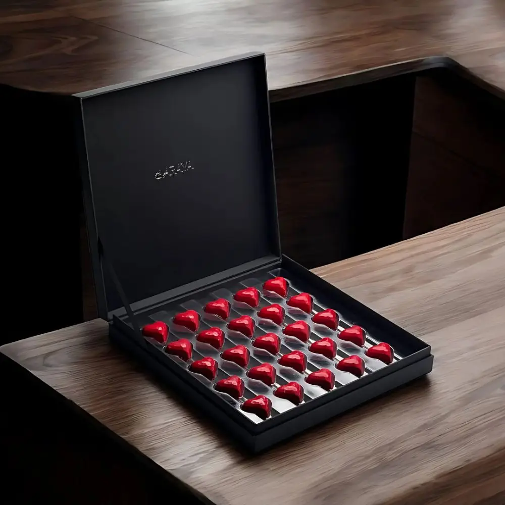 Opulence Valentine’s Collection: Premium Love Box by AARAYA®, featuring 25 red heart-shaped premium chocolates in a sleek black box