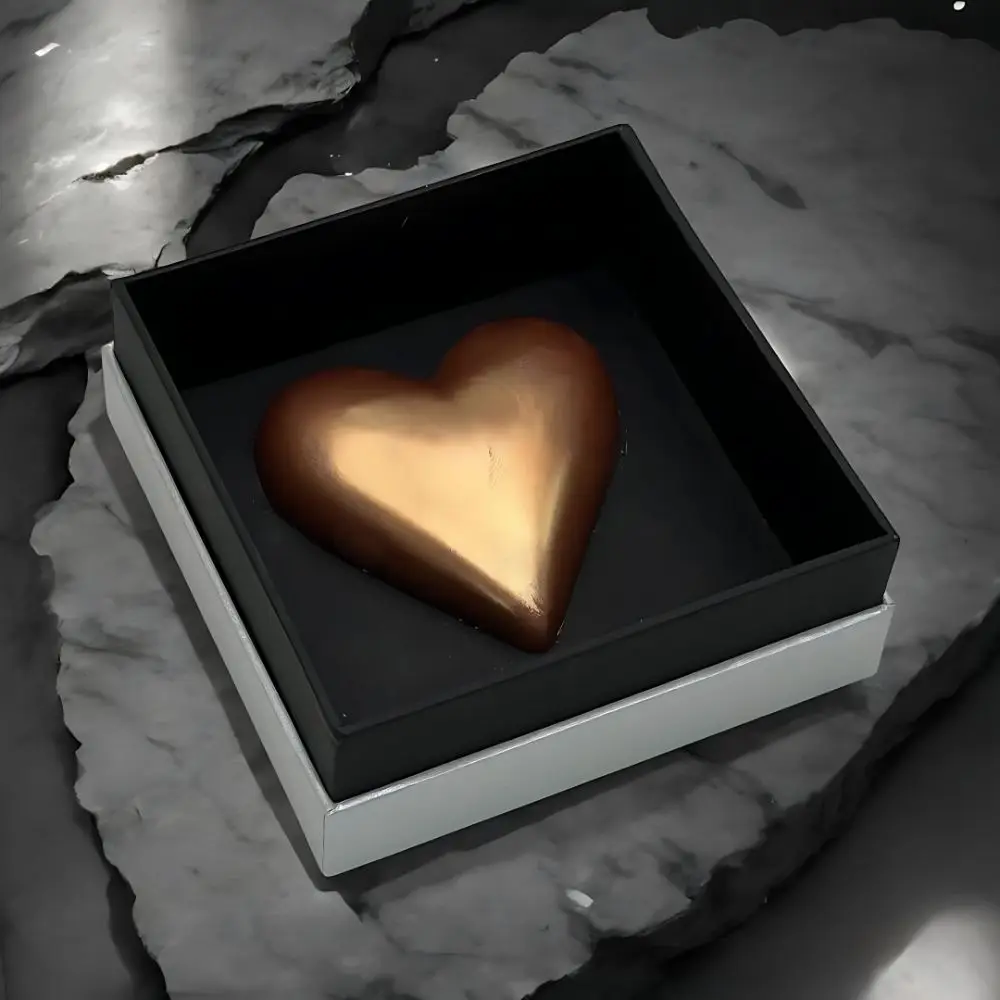 Heart of King Valentine's Chocolate Collection by AARAYA®, featuring a handcrafted golden heart-shaped premium chocolate in a sleek silver and black box